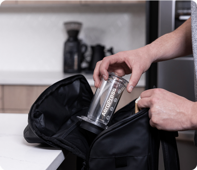 AeroPress Clear being placed into backpack