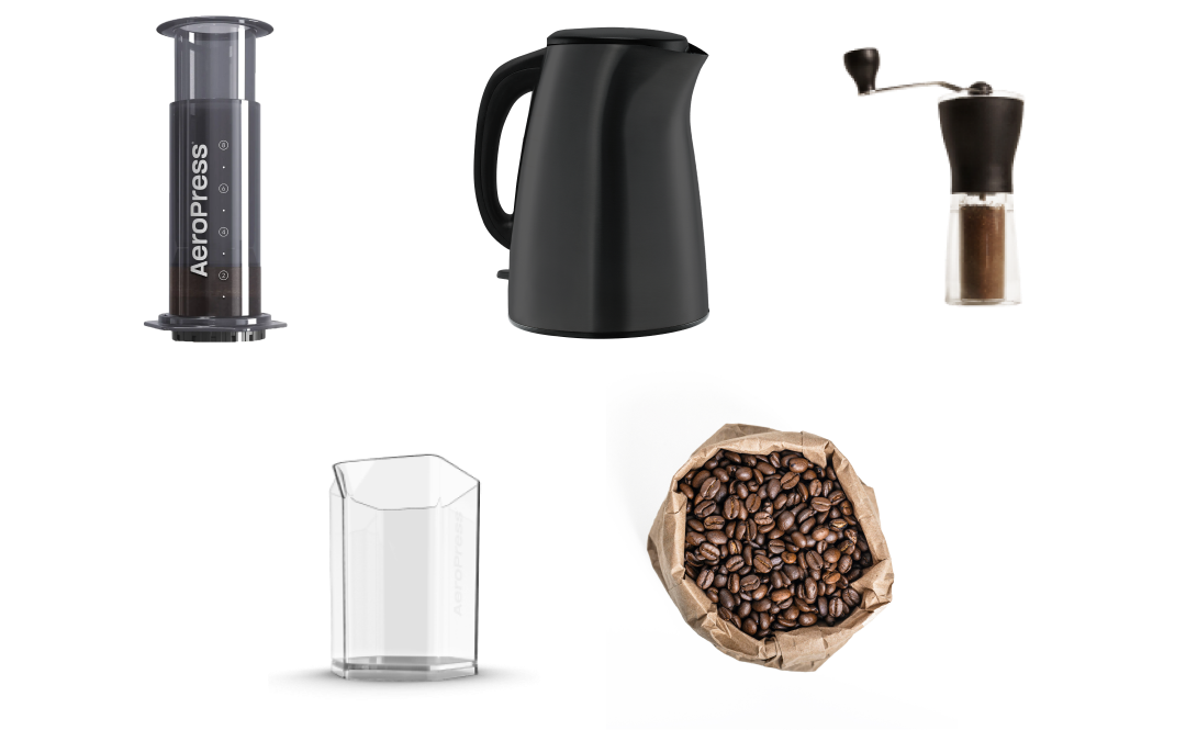 AeroPress XL next to kettle, hand grinder, carafe and coffee beans