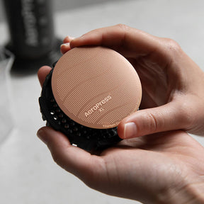 Gold Tone Filter XL size being placed into an XL filter cap