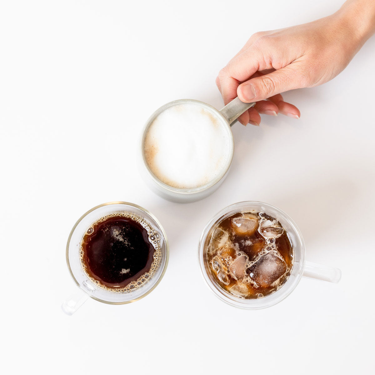 Photo of three cups of coffee: regular coffee, cold brew coffee, and a latte