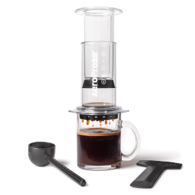 AeroPress Clear Coffee maker with a mug of coffee on a white background