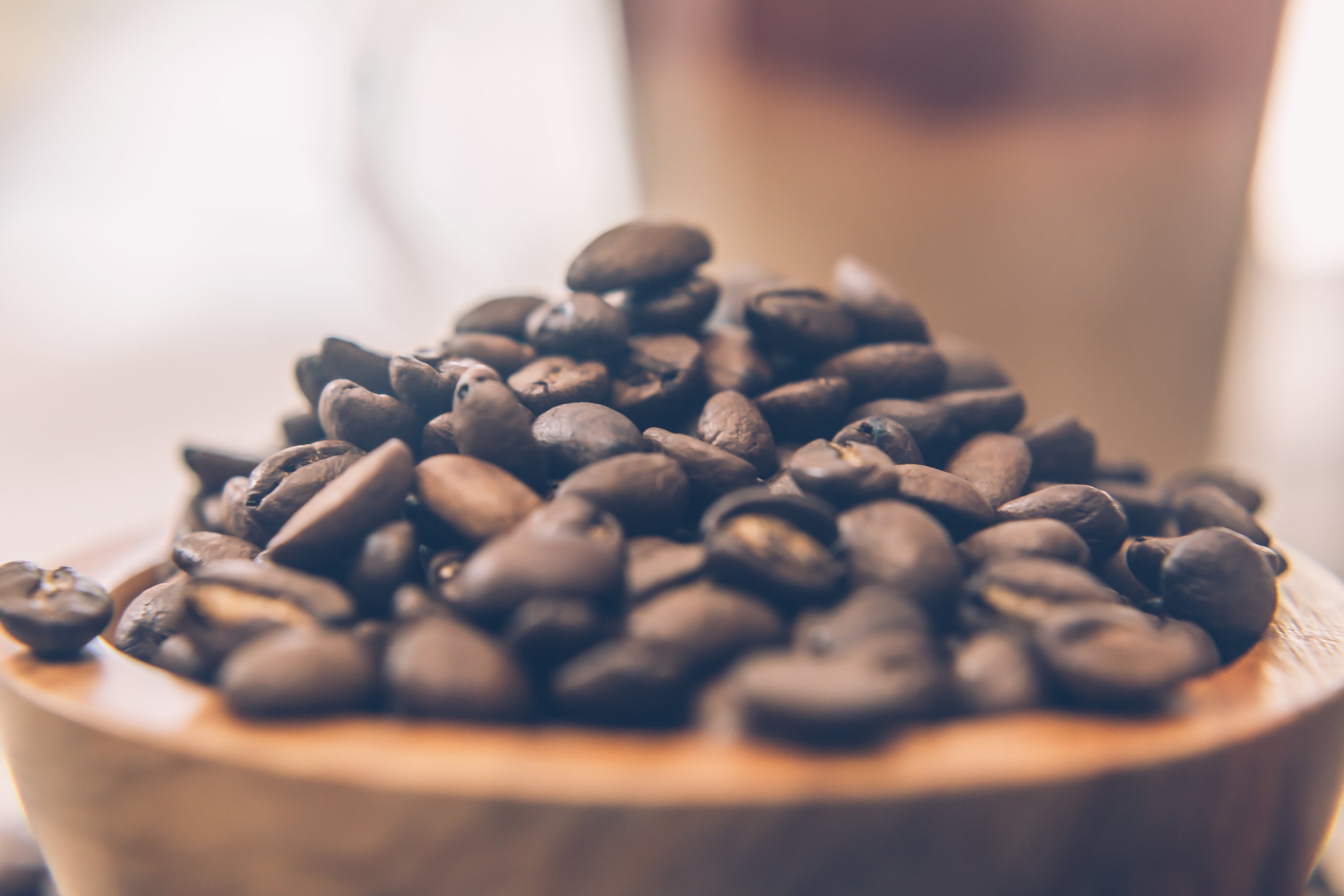 Coffee beans in a wooden bowl