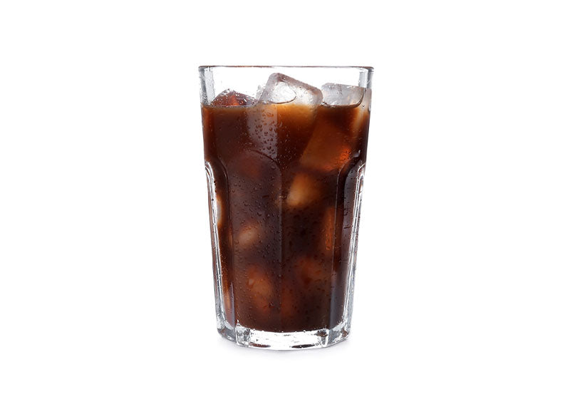 Glass containing cold brew coffee and ice cubes