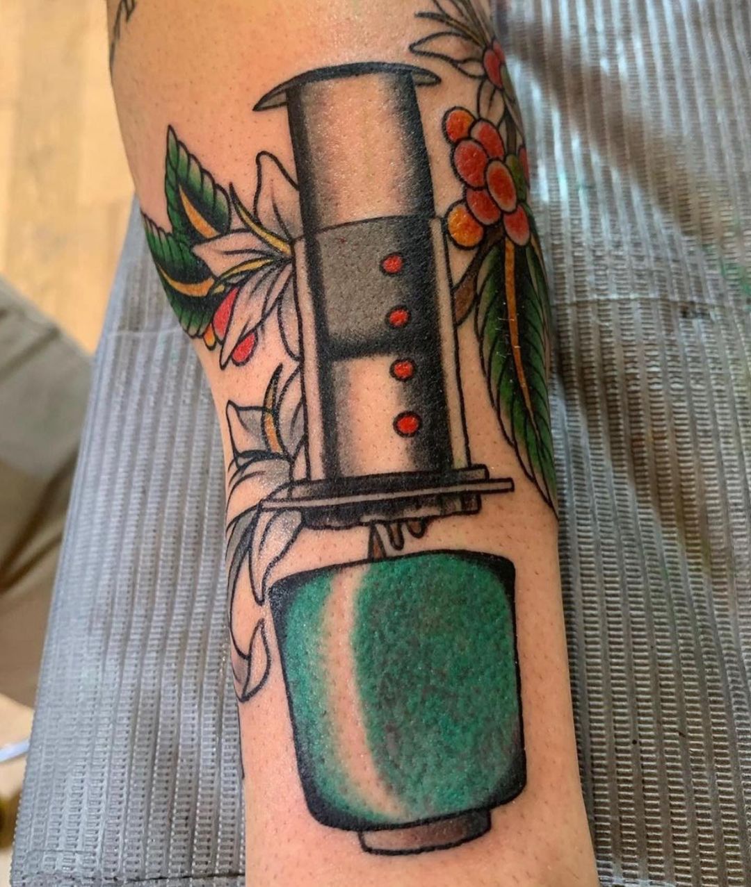 AeroPress tattoo with green cup and flowers
