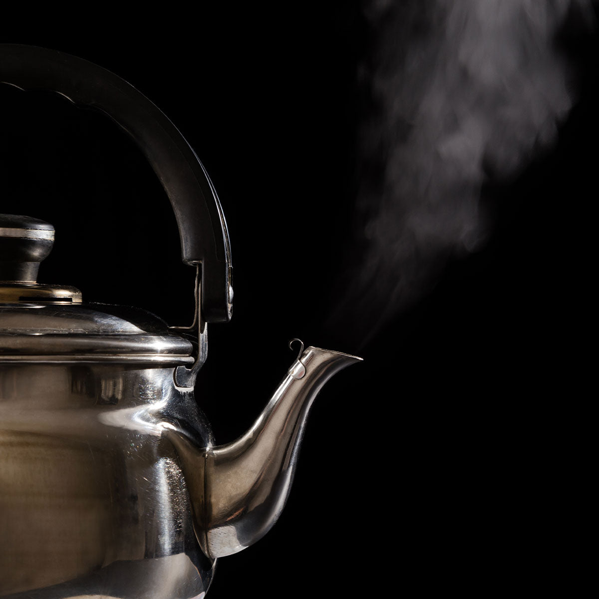 A kettle boiling with steam coming out of spout